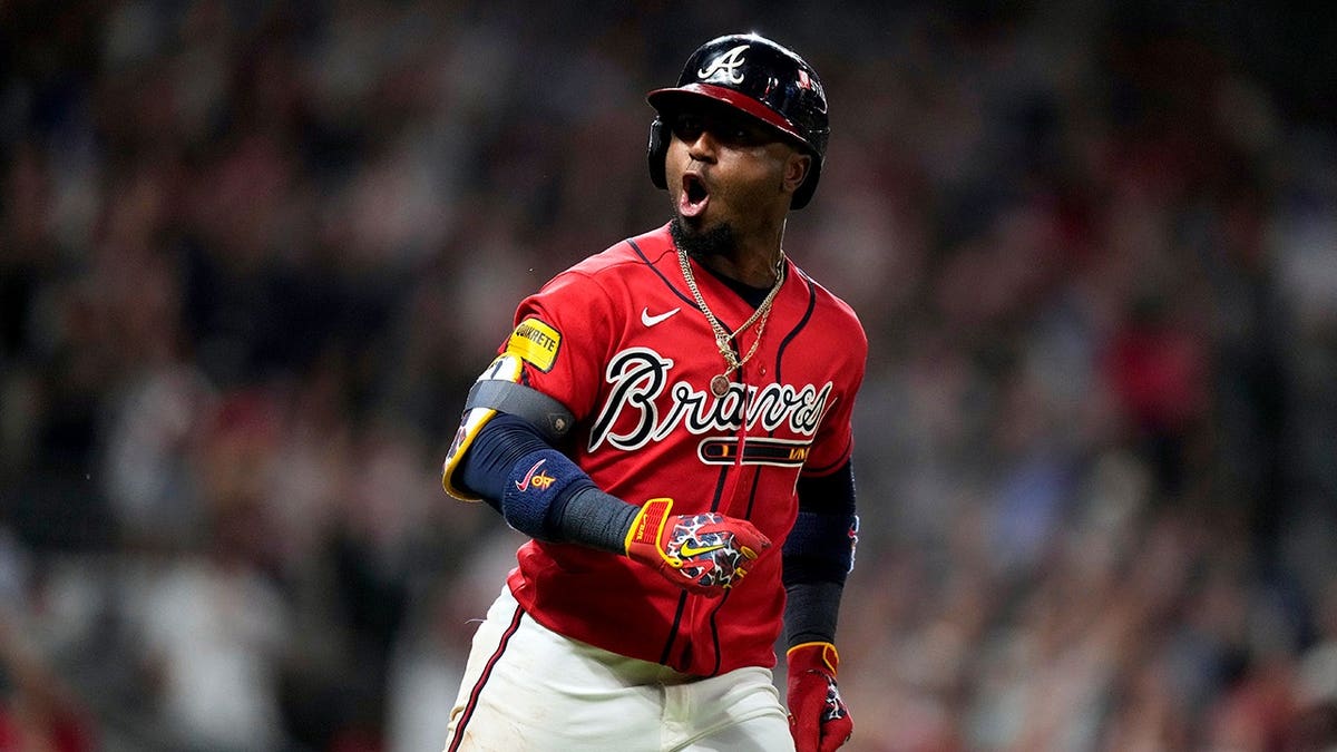 Ozzie Albies celebrates after hitting a two-run home run against the Philadelphia Phillies.
