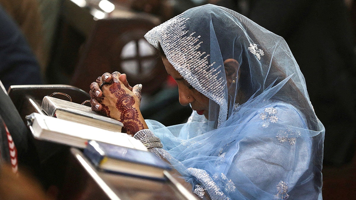 Pakistani woman prays in Church