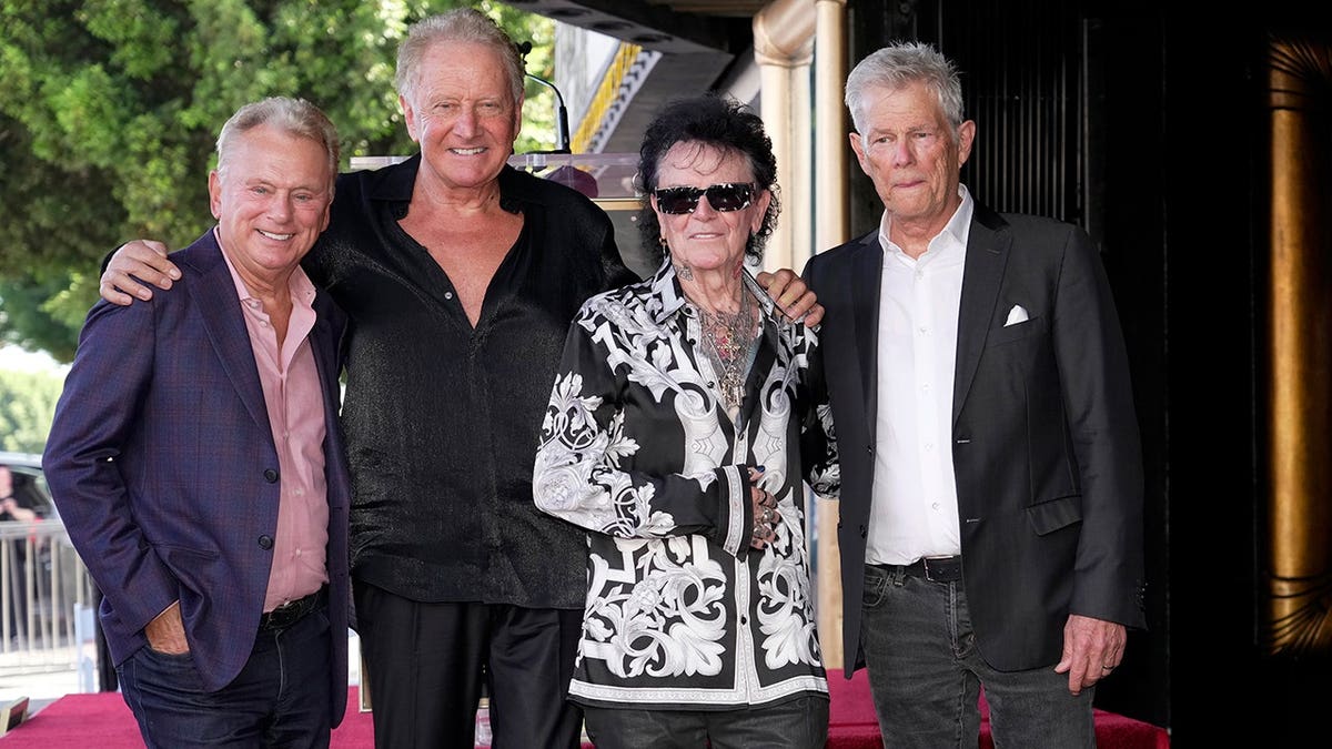Pat Sajak posing with Air Supply on the Hollywood Walk of Fame in October 2026