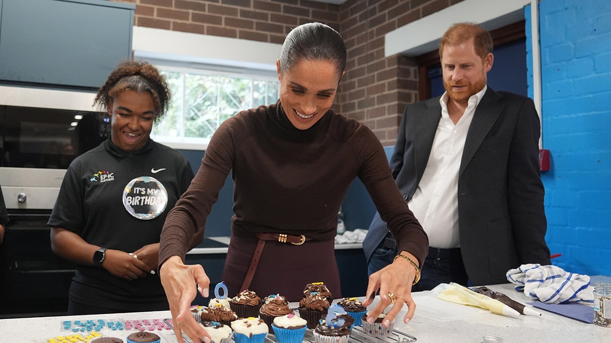 Meghan Markle serving cupcakes.