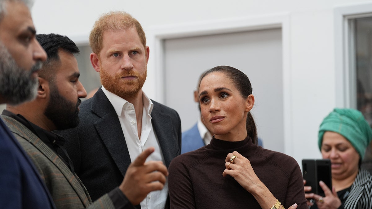Meghan Markle looking at Prince Harry as he speaks.