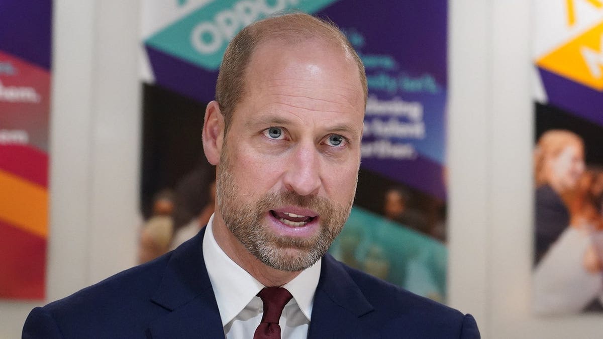 Prince William reacts while meeting scholars and alumni of The Amos Bursary in London.
