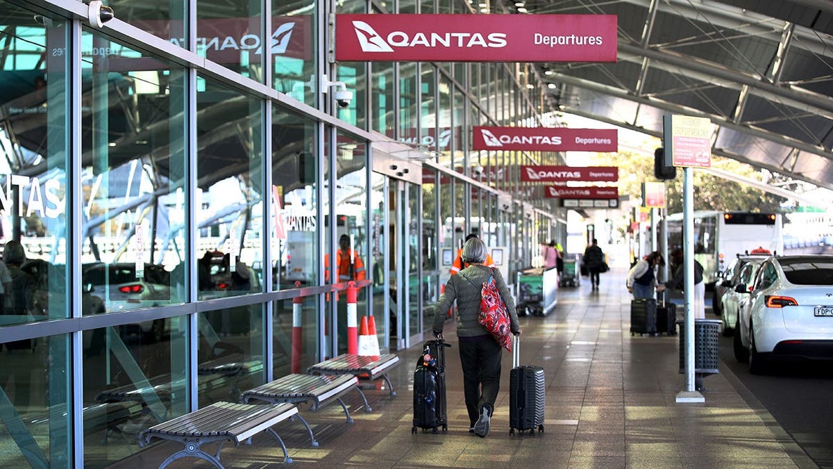 Travellers arrive at Qantas domestic terminal at Sydney Airport