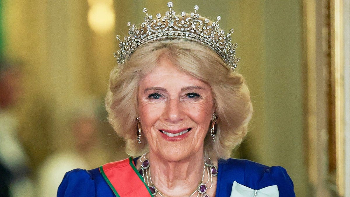 Queen Camilla in formal attire with tiara at Windsor Castle.