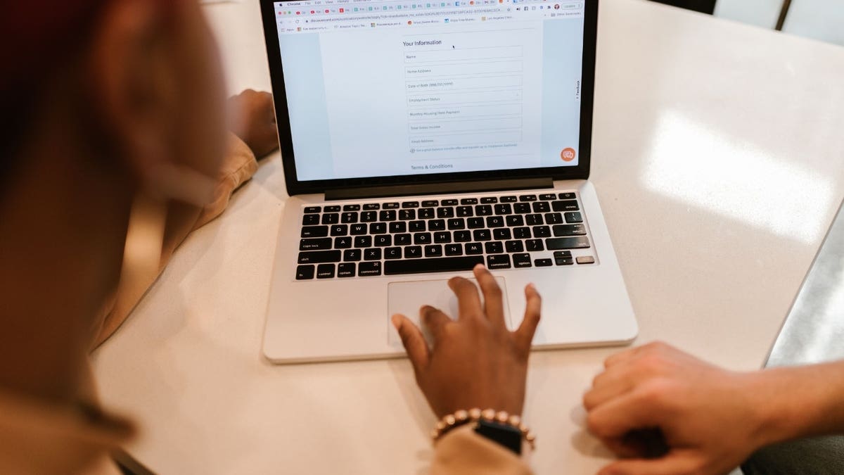 a person typing on a laptop