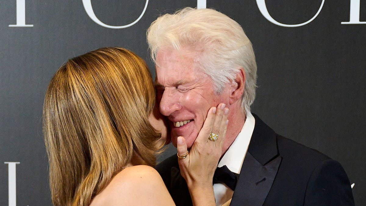 Richard Gere and Alejandra Silva attend a photocall at the Four Seasons Hotel in Madrid.