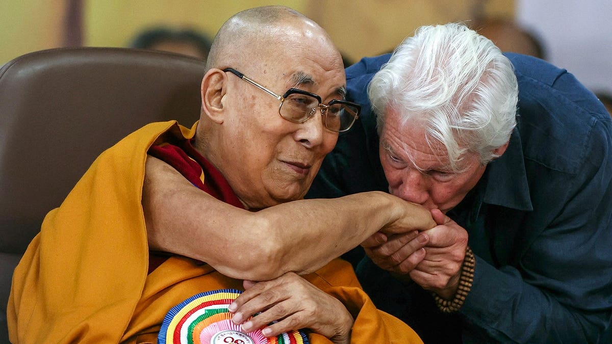 Richard Gere kisses the Dalai Lama's hand during a prayer ceremony at the Main Tibetan Temple.