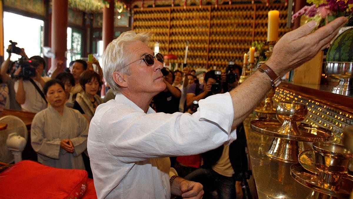 Richard Gere prays inside a Buddhist temple in Seoul.