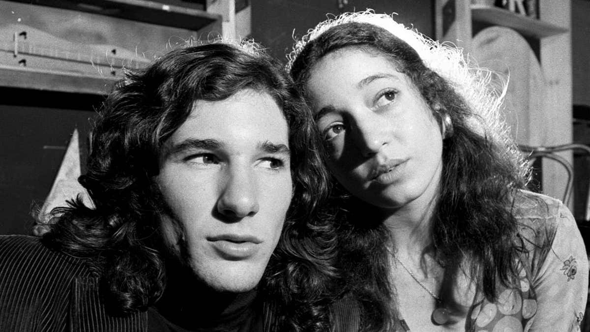 Richard Gere and Vicki Sue Robinson stand together in a Broadway theater scene from 1971.