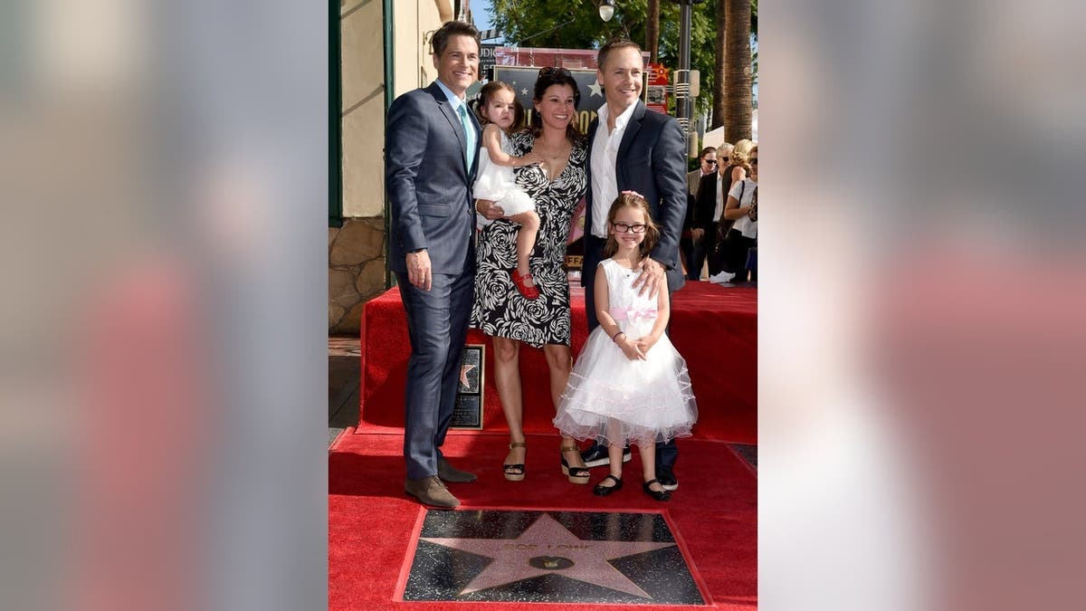 Rob Lowe stands with his brother Chad Lowe and family members at his Hollywood Walk of Fame star ceremony.