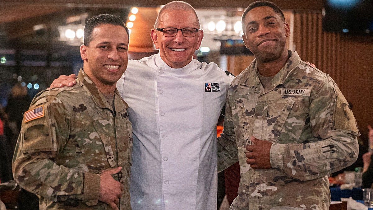 Chef Robert Irvine smiling with Army soldiers.