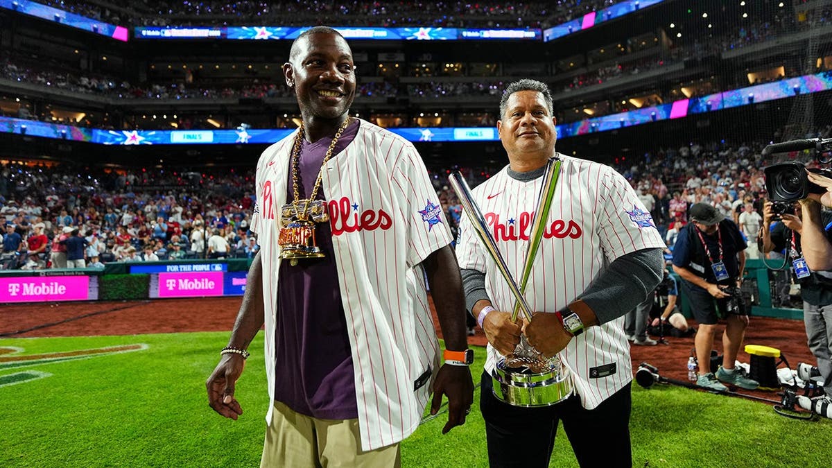 Ryan Howard and Bobby Abreu hold the trophy during the 2026 T-Mobile Home Run Derby at Citizens Bank Park.