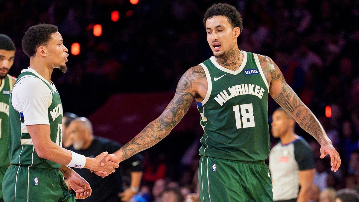 Ryan Rollins celebrates a basket with Kyle Kuzma during an NBA game in Philadelphia.