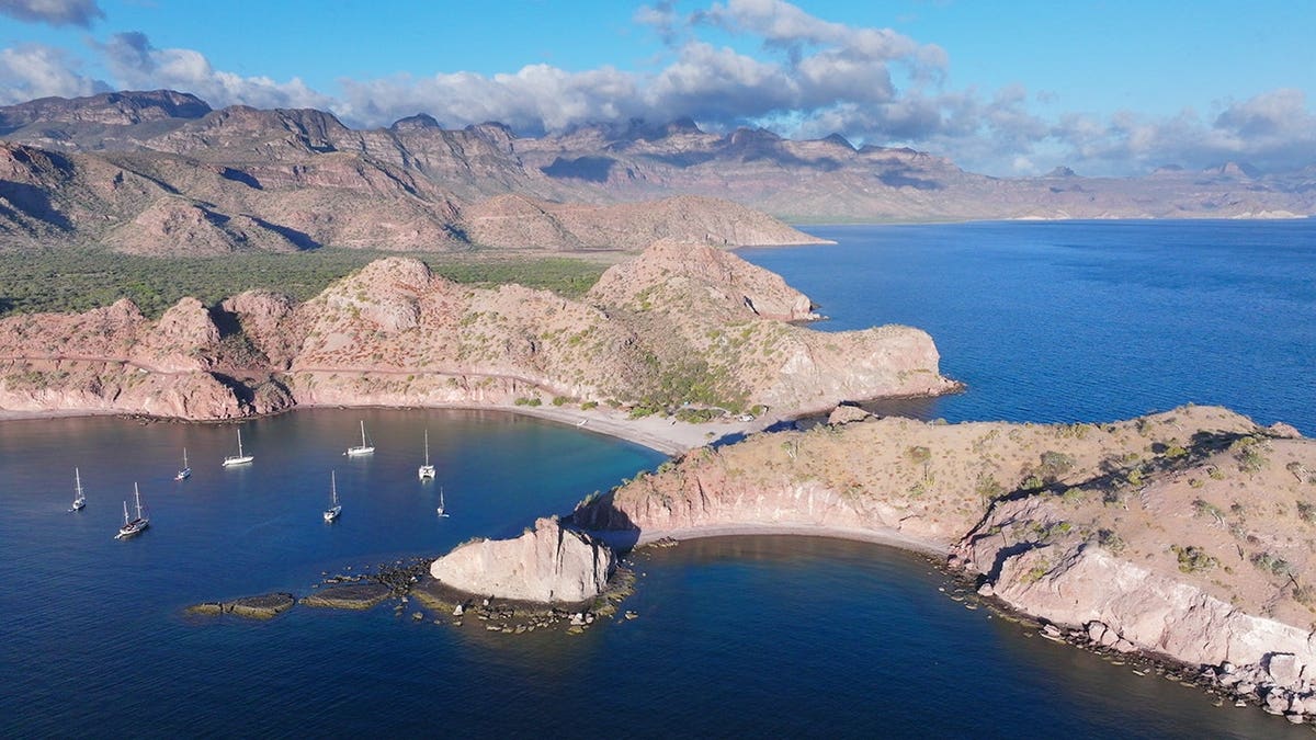 Sailboats sit below the Sierra Mountains at Agua Verde, Baja California Sur.