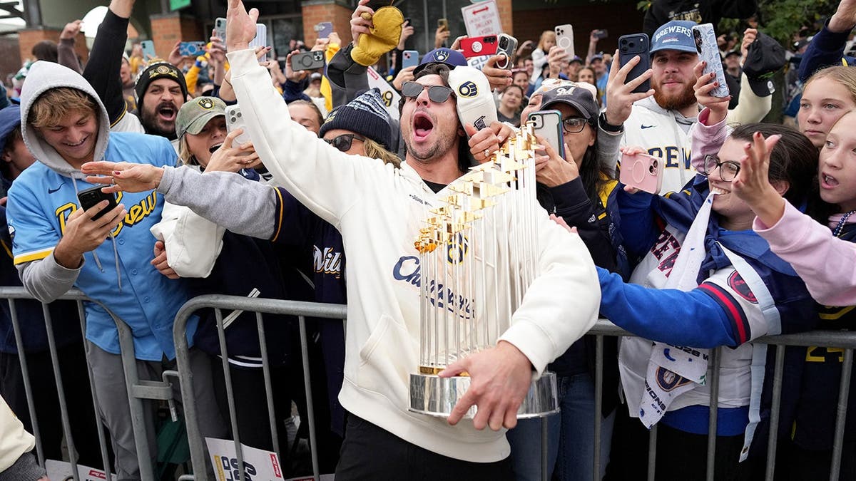 Sal Frelick celebrates with fans during the Milwaukee Brewers Victory Parade.