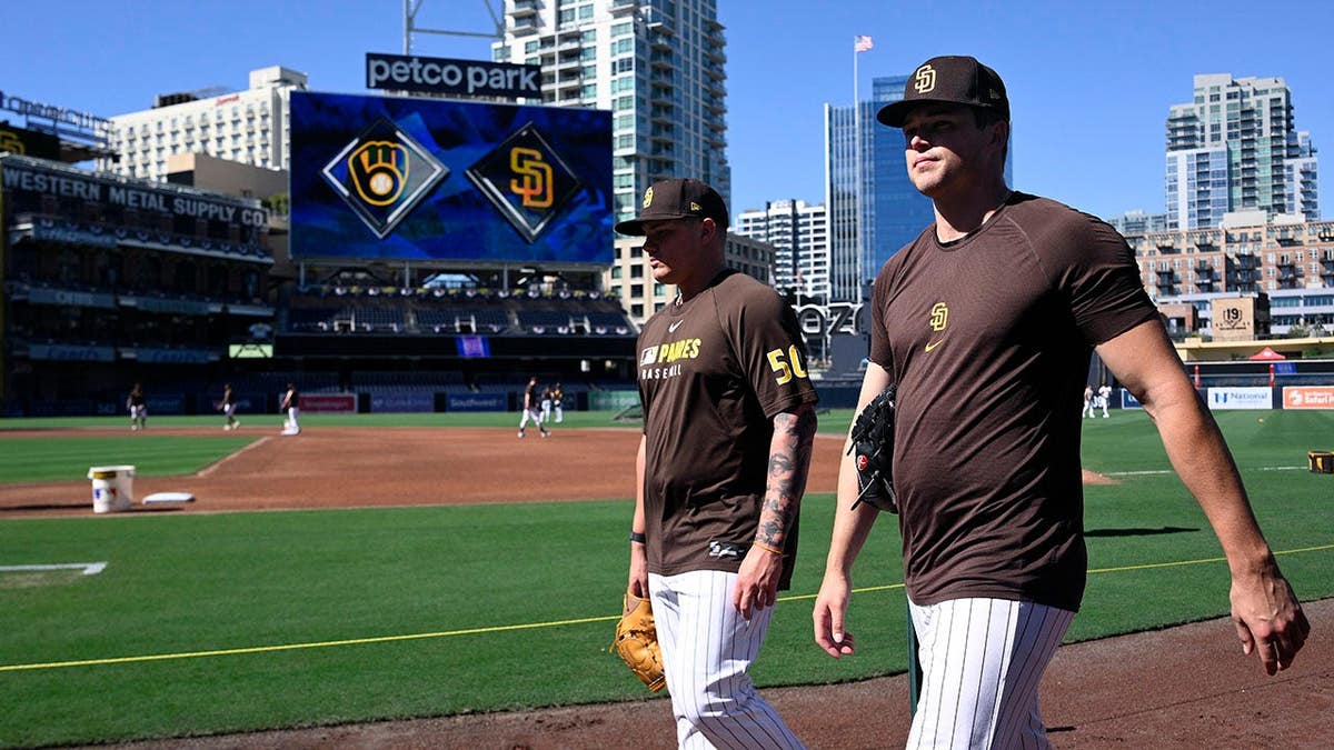 Adrian Morejon and Mason Miller look on during workouts at Petco Park.