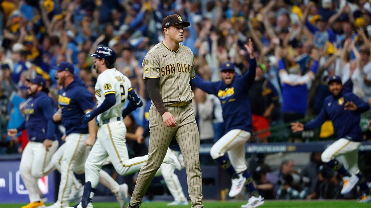 Mason Miller #22 of the San Diego Padres walks off the field after giving up a game-winning two-run single.