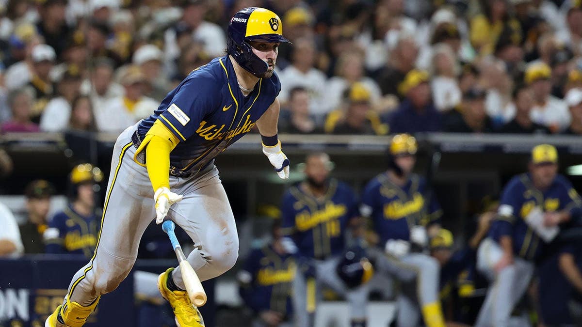 Garrett Mitchell drops his bat and runs after hitting a triple at Petco Park.