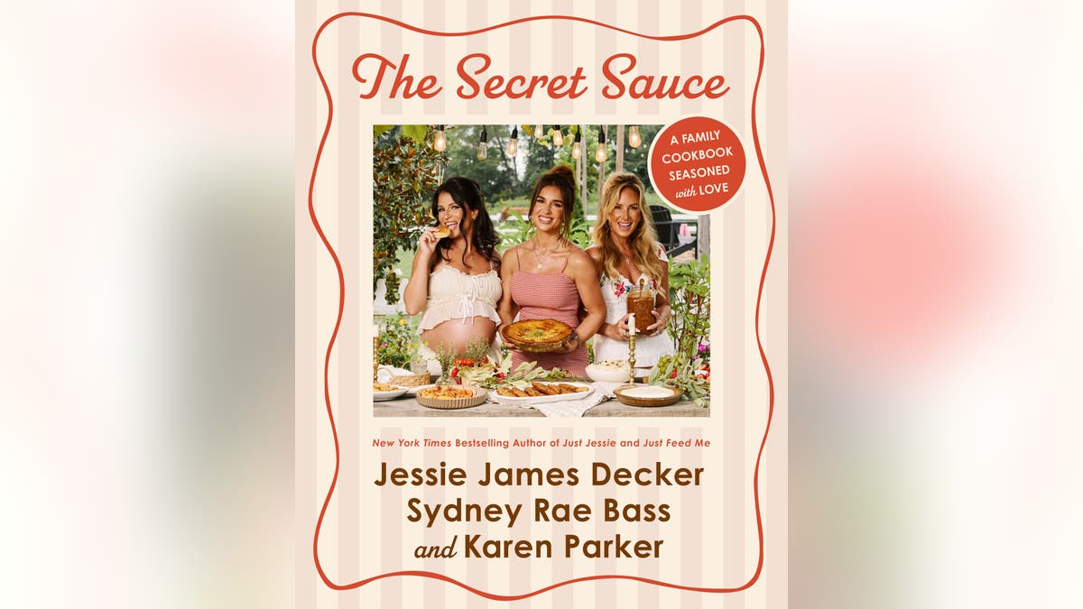 Sydney Bass, Jessie James Decker and Karen Parker pose behind a table of prepared dishes on the cover of The Secret Sauce cookbook.