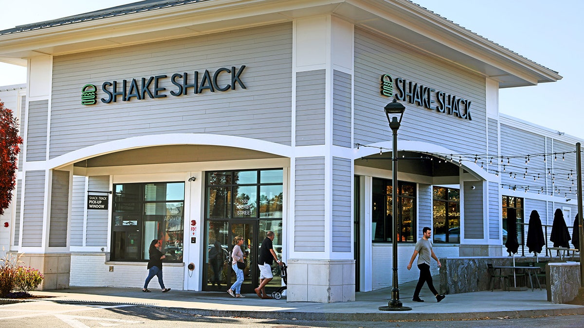 People walking outside Shake Shack in Mass.