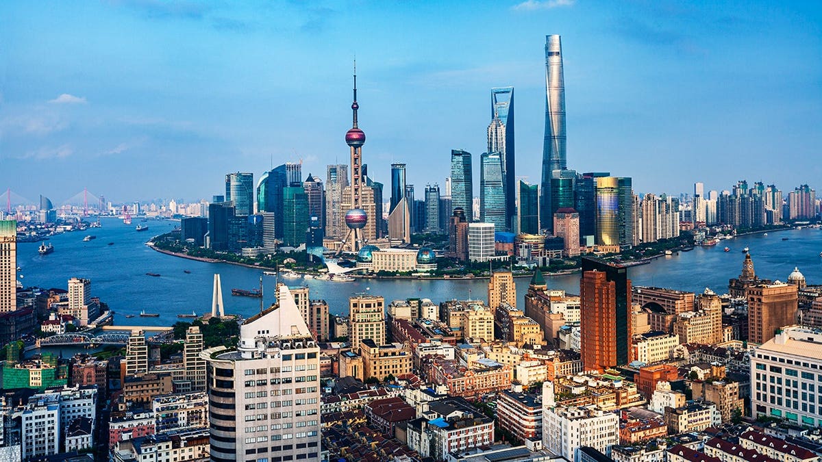 Shanghai skyline with modern tall buildings across the horizon.