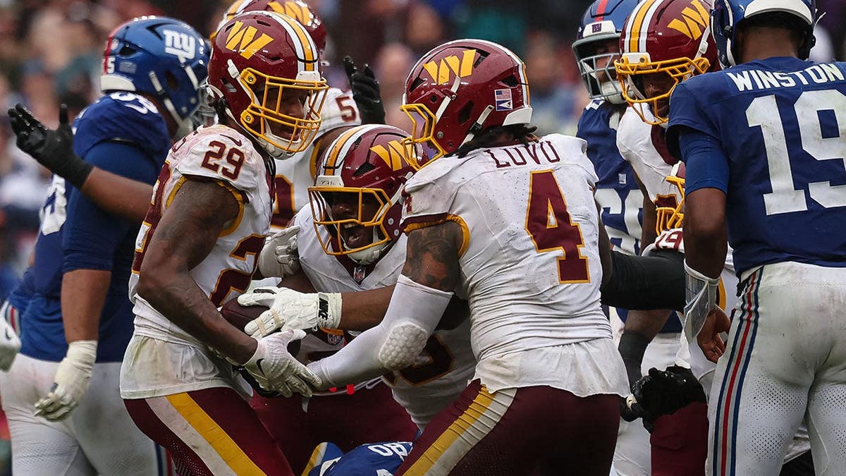 Shy Tuttle celebrates after recovering a fumble during overtime in an NFL game.