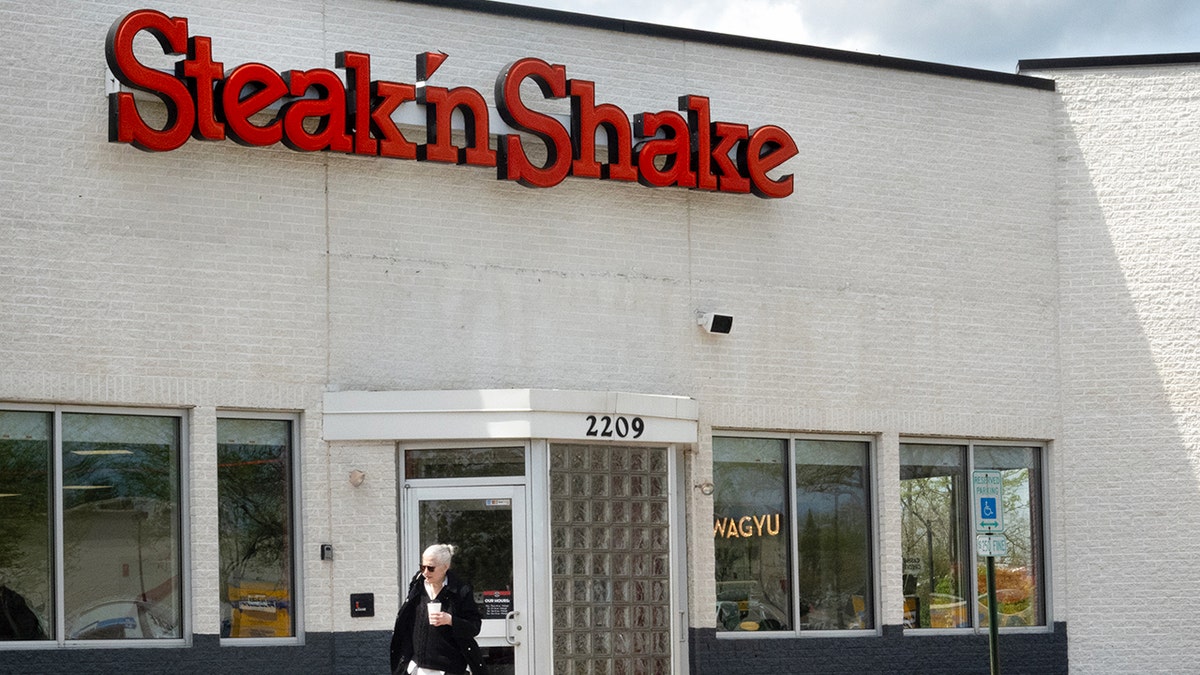 A customer leaves a Steak 'n Shake restaurant.