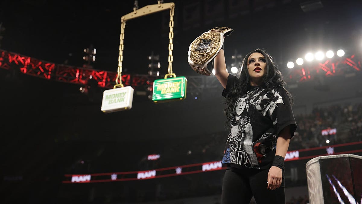 Stephanie Vaquer holds up her Women's World Championship at Enterprise Center.