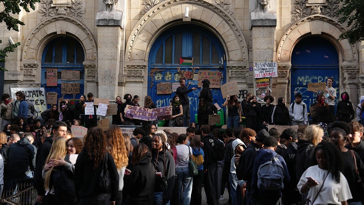 Students block the entrance of Voltaire high school in Paris during a protest.