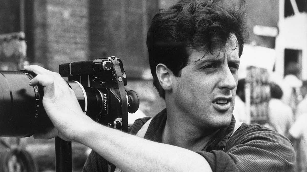 Sylvester Stallone takes still photos on a film set in Dubuque.
