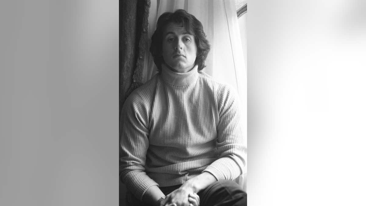 Sylvester Stallone stands in a hotel room in New York City.