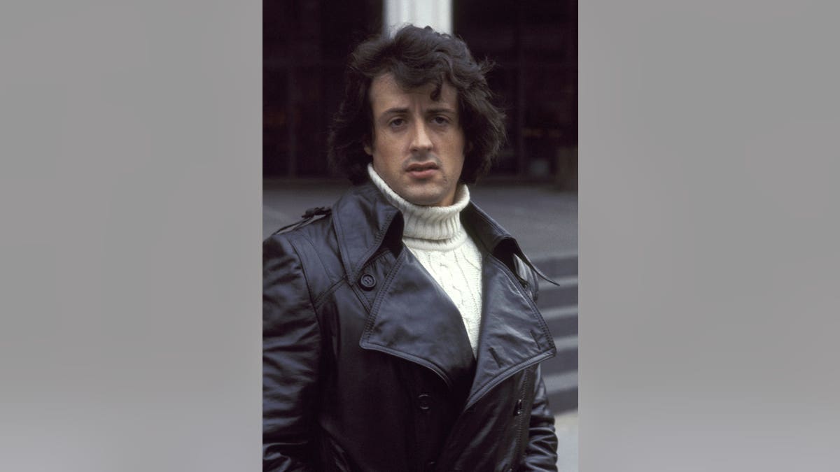 Sylvester Stallone stands at the New York premiere of Rocky at Paramount Theater.