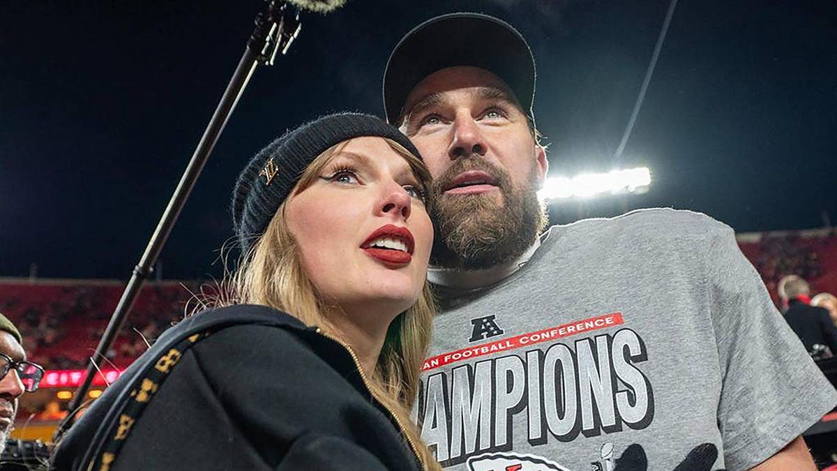 Taylor Swift and Travis Kelce walk off the field after the AFC Championship Game trophy ceremony.