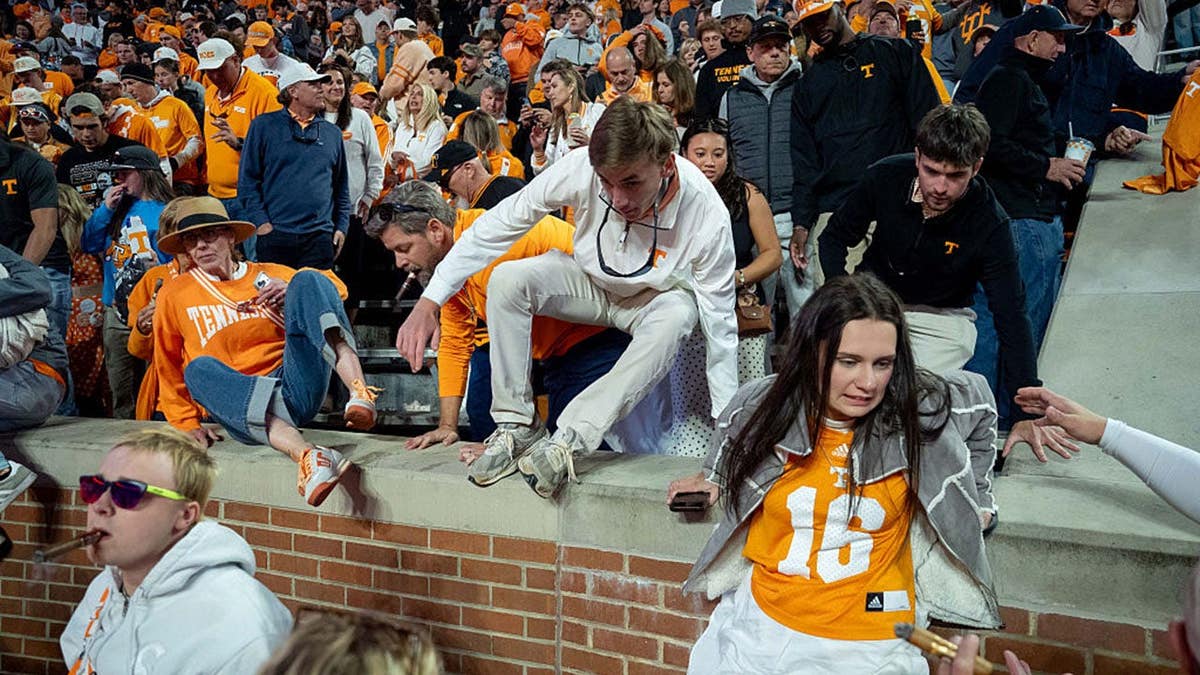Fans rush onto the field at Neyland Stadium after Tennessee defeats Alabama.