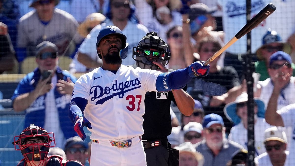 Teoscar Hernández watches his two-run home run during a baseball game in Los Angeles.