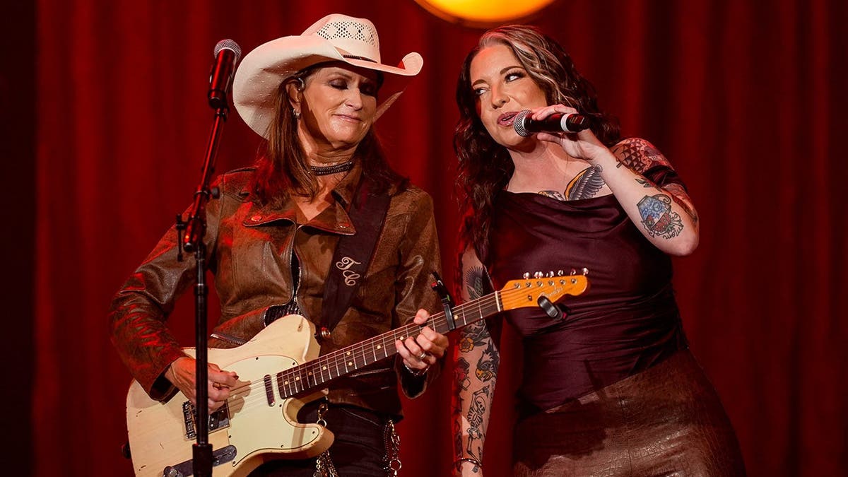 Terri Clark and Ashley McBryde perform on stage at the Ryman Auditorium.
