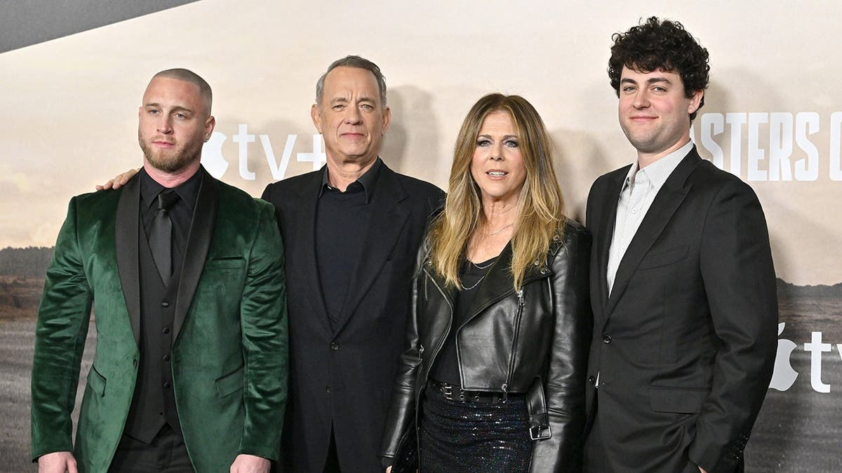 Tom Hanks, Rita Wilson, Chet Hanks and Truman Hanks stand together at a premiere event.