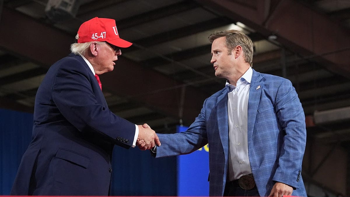 President Donald Trump greets Aaron Flint at a campaign rally in Kalispell, Montana.