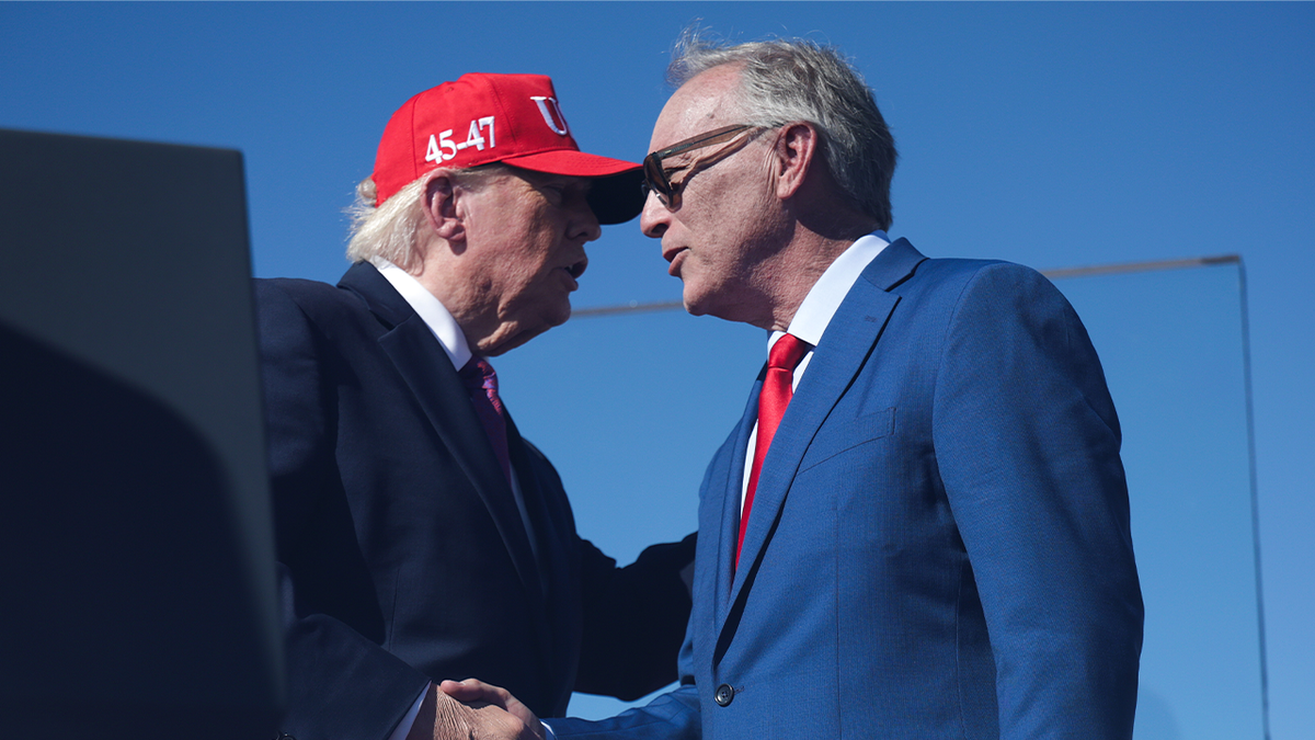 President Donald Trump shakes hands with Andy Biggs at a campaign rally in Bullhead City, Arizona