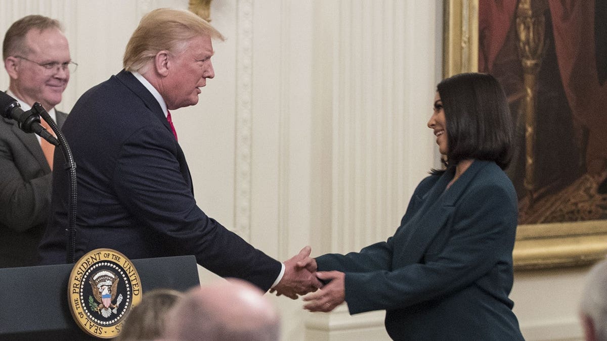 Kim Kardashian shaking hands with President Donald Trump while at the White House in 2019.