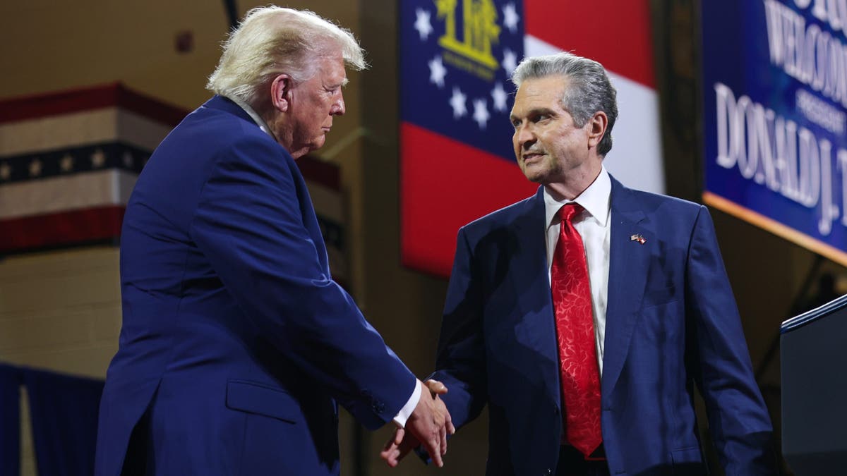 President Donald Trump shakes hands with Georgia Republican gubernatorial candidate Rick Jackson
