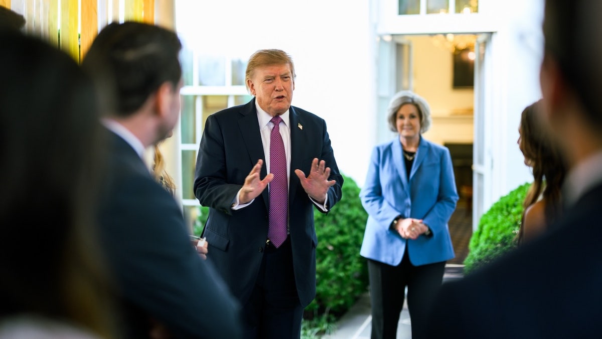 Trump speaking - Susie Wiles in background