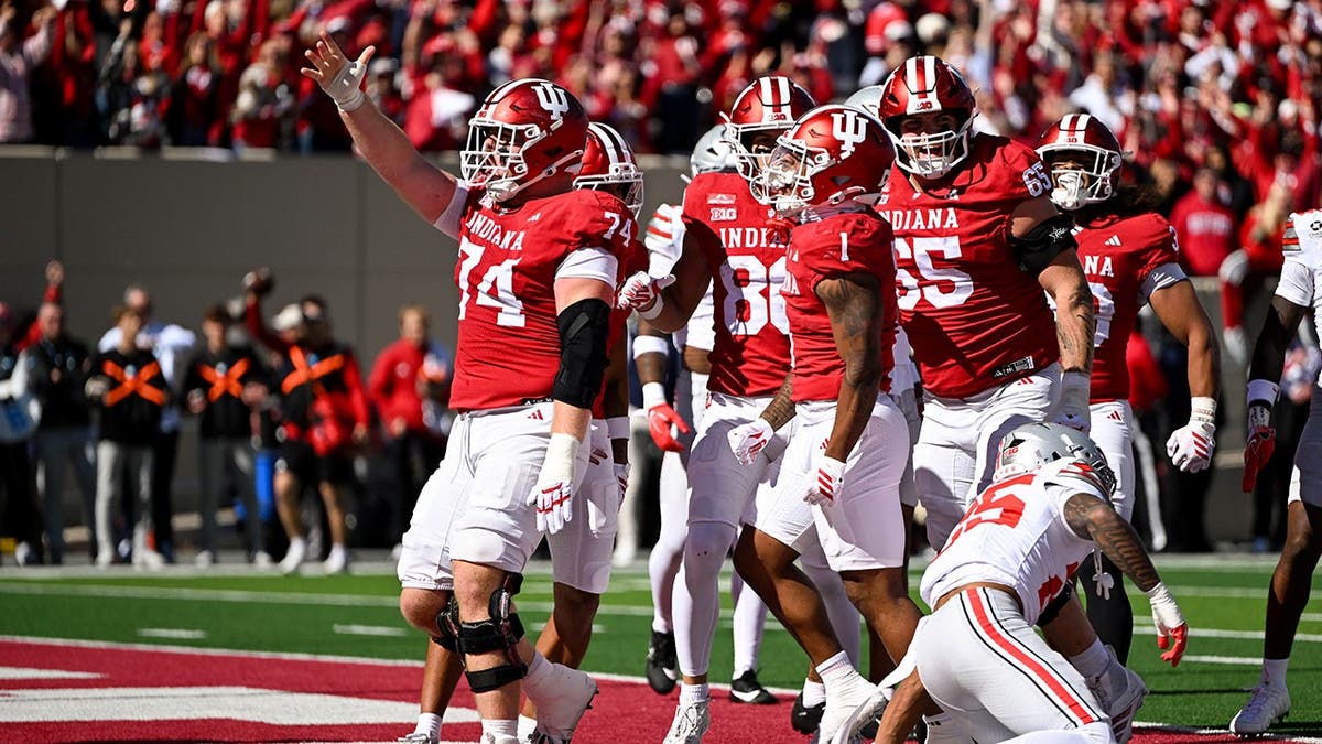 Turbo Richard and Bray Lynch celebrate a touchdown with teammates.