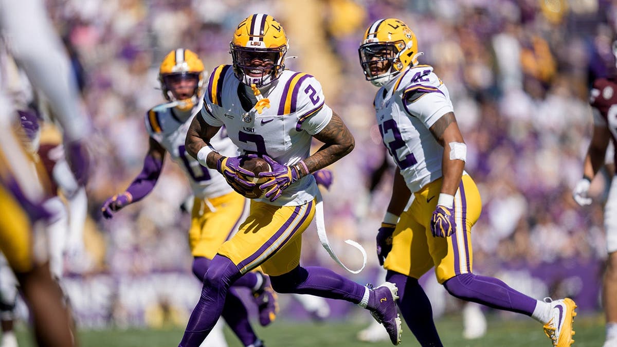 Ty Benefield celebrates after intercepting a pass during an NCAA college football game.