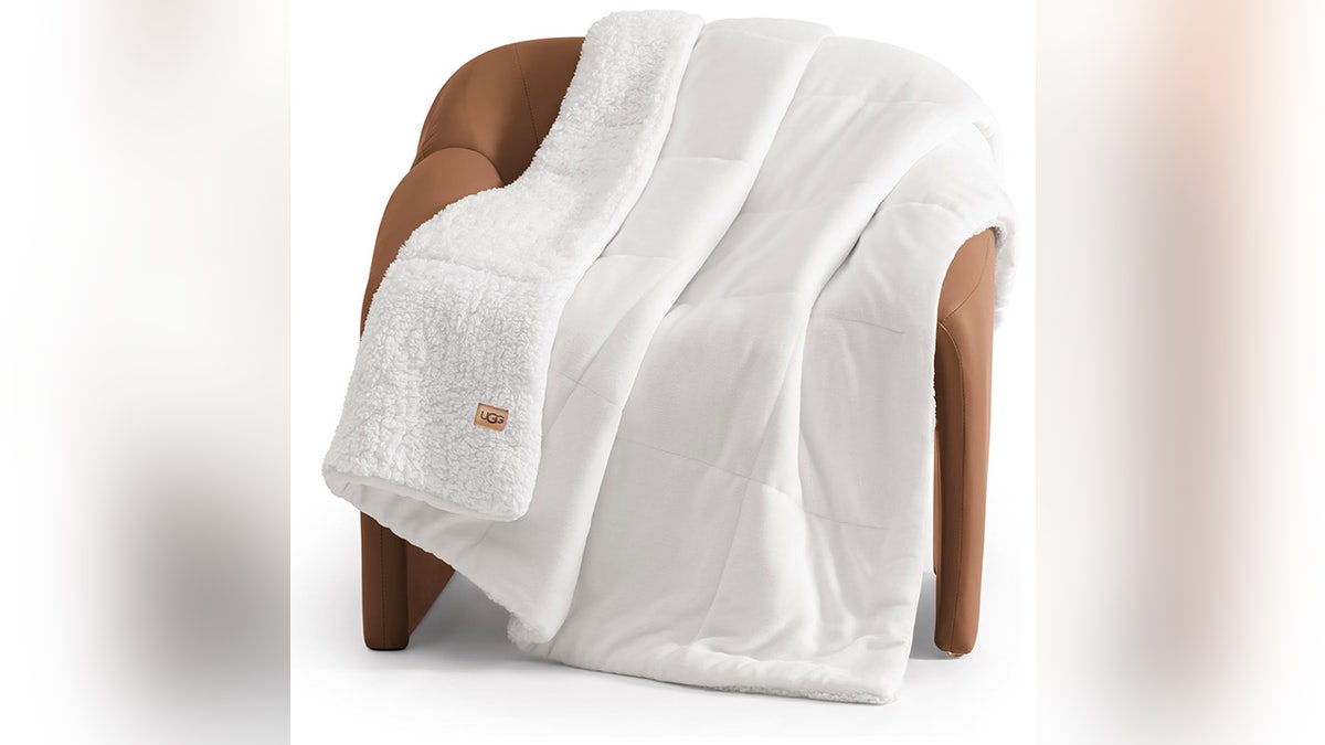 Cuddle up in this soft Ugg blanket.