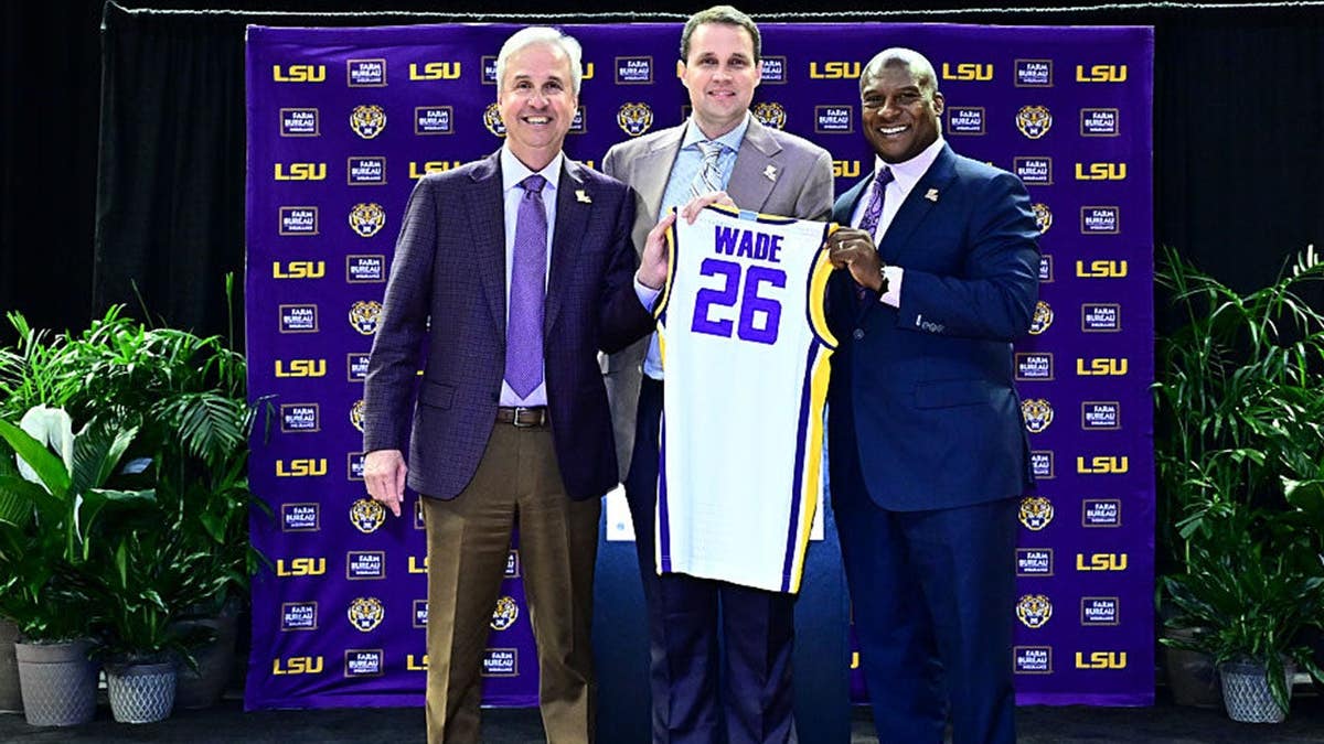 Will Wade, Wade Rousse and Verge Ausberry pose together at a press conference.
