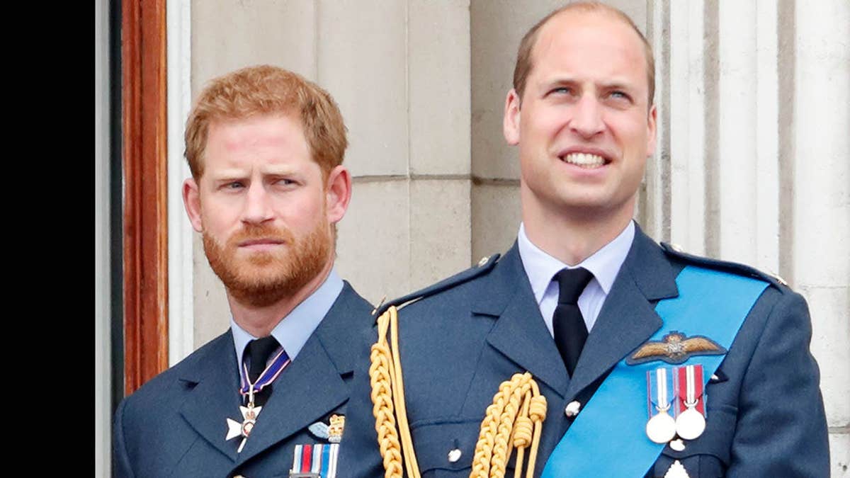 Prince Harry and Prince William watch a Royal Air Force flypast from Buckingham Palace balcony.