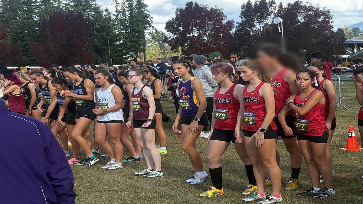 A Camas High cross country runner, who switched from the boys team to the girls team midseason, stands at the start line of a girls race in at the Nike Hole in the Wall XC Invitational.