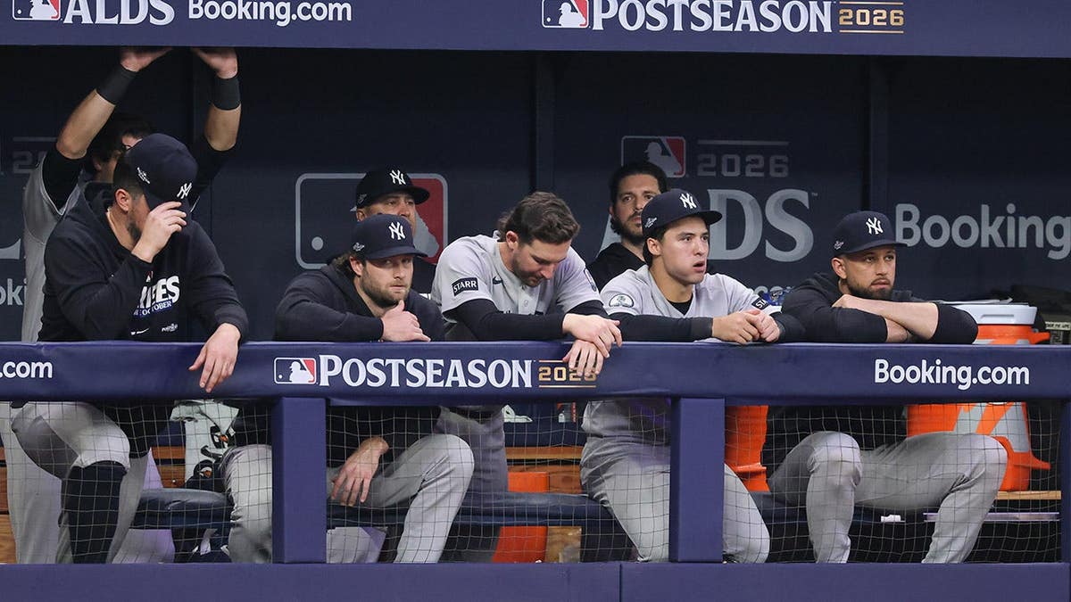 New York Yankees members look on from the dugout during Game 2 of the ALDS.