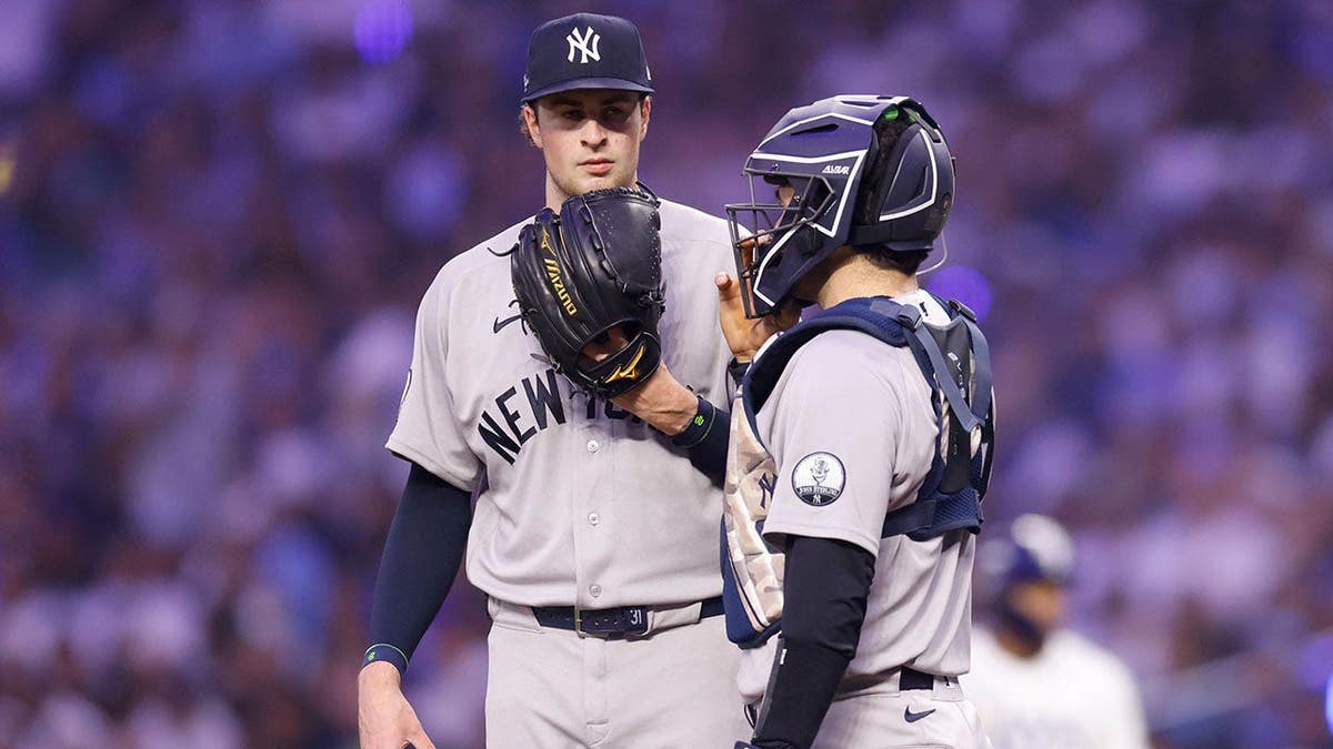 Cam Schlittler and Austin Wells of the New York Yankees talk on the mound during Game 2 of the American League Division Series.